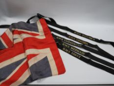 A COLLECTION OF ROYAL NAVY HAT BANDS AND A VINTAGE UNION JACK FLAG