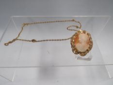 A HALLMARKED 9 CARAT GOLD MOUNTED PENDANT/BROOCH ON A CHAIN STAMPED 9CT approx weight 12.3g