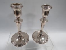 A GOOD PAIR OF WEIGHTED HALLMARKED SILVER CANDLESTICKS H 17 CM