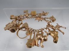 A HALLMARKED 9 CARAT GOLD CHARM BRACELET approx weight 41.6G