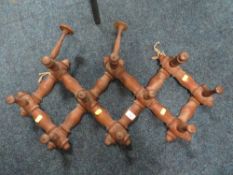 A VINTAGE SET OF FOLDING CONCERTINA COAT/HAT HOOKS