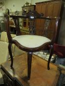 AN ANTIQUE CARVED MAHOGANY CORNER CHAIR