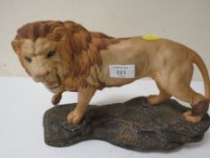 A BESWICK LION ON A ROCK