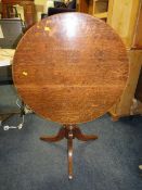 A 19TH CENTURY CIRCULAR OAK TILE TOP TABLE