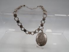 AN ANTIQUE HALLMARKED SILVER COLLARETTE LOCKET