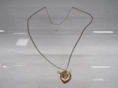 AN LOCKET ON CHAIN MARKED 9CT GOLD BACK AND FRONT