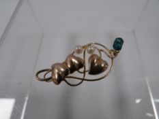 AN ANTIQUE 9CT GOLD PENDANT BY MURRLE BENNETT