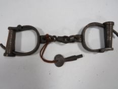 A PAIR OF VICTORIAN HAND CUFFS