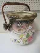 A VINTAGE CERAMIC DRAINING POT WITH WICKER WORK HANDLE