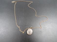 A VICTORIAN LOCKET ON CHAIN