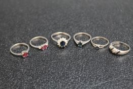 A COLLECTION OF FIVE SILVER AND WHITE METAL RINGS SET WITH ASSORTED SEMI PRECIOUS STONES