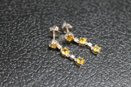 A PAIR OF EARRINGS SET WITH CITRINE STYLE STONES AND DIAMONDS, just butterflies stamped 750,