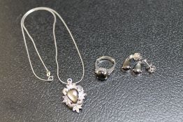 A WHITE METAL PENDANT, EARRINGS AND RING SET ALL WITH IRIDESCENT STONES, possibly 'Star Sapphires',