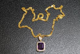 AN AMETHYST AND DIAMOND PENDANT, set in unmarked yellow metal on an unmarked yellow metal chain with