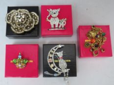 FOUR BUTLER AND WILSON BROOCHES, to include a cat sat in a moon - L 12 cm and a brushed gilt charm