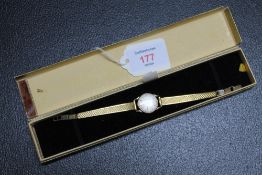 A 9 CARAT GOLD LADIES OMEGA WRIST WATCH, on replacement plated strap and lacking winder, Dia 2 cm