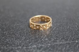 A 9CT WEDDING BAND, set with small white stones, approx weight 3.7g, ring size P