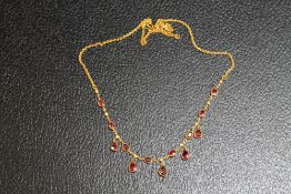 A YELLOW METAL RUBY AND DIAMOND NECKLACE, on a simple s shaped attachment, approx weight 8.4g, L