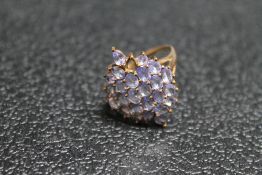 A HALLMARKED 9 CARAT GOLD DRESS RING, set with tanzanite style stones, approx weight 3.1g, ring size