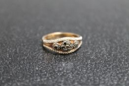 A WHITE AND BLACK DIAMOND SET DRESS RING, set in unmarked yellow metal, approx weight 2.9g, ring