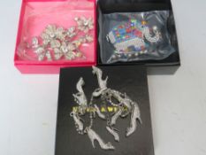 TWO BUTLER AND WILSON COSTUME BROOCHES, comprising an elephant - W 8.5 cm, and a floral spray - W 11