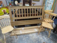 A MODERN OAK BED FRAME ALONG WITH THREE KITCHEN CHAIRS