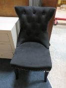 A MODERN UPHOLSTERED DINING CHAIR WITH RING HANDLE