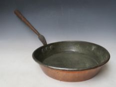 A LARGE 19TH CENTURY COPPER FRYING PAN, with cast metal handle, Dia. 34 cm, overall L 74 cm