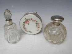 ENAMEL TOPPED CIRCULAR WHITE METAL BOX, Dia. 8.5 cm, together with two cut glass scent bottles