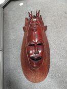 A LARGE CARVED TRIBAL WALL MASK