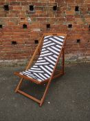 A STRIPED / ZEBRA PATTERN MODERN FOLDING DECK CHAIR