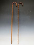 A VINTAGE EASTERN CARVED MALACCA WALKING STICK, L 88 cm, together with another walking stick (2)