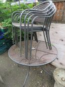 A ROUND METAL FIVE PIECE GARDEN TABLE SET WITH FOUR STACKING CHAIRS