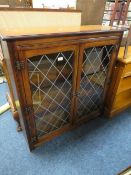 A TWO DOOR LEADED BOOKCASE