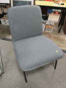 A MODERN GREY CHAIR ON BLACK METAL LEGS