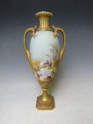 A ROYAL WORCESTER TWIN HANDLED PEDESTAL VASE BY W. POWELL, decorated with storks in a landscape,