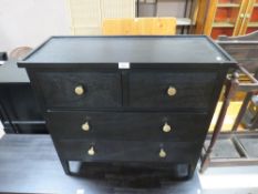 A MODERN BLACK FOUR DRAWER CHEST