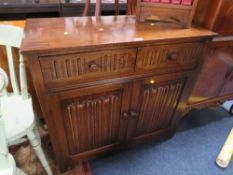 AN OAK LINEN FOLD DRESSER BASE