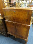 A VINTAGE WALNUT DRINKS CABINET