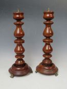 A PAIR OF 19TH CENTURY TURNED WALNUT PRICKET CANDLESTICKS, H 32 cm
