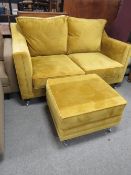 A MODERN MUSTARD TWO SEATER SQUARE HIGH BACKED SOFA WITH FOOTSTOOL