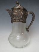 AN ART NOUVEAU SILVERPLATE AND GLASS CLARET JUG, the glass body having engraved sinuous foliate