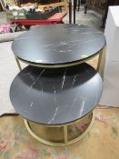 A MODERN CIRCULAR COFFEE TABLE TOGETHER WITH A SMALLER TABLE FAUX MARBLE TOPS