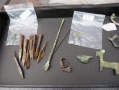 A CASE OF ROMAN, MEDIEVAL AND OTHER ANTIQUITIES, to include brooches, rings, rings, arrow heads etc