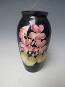 A MOORCROFT FLORAL PATTERN BALUSTER VASE, H 19 cm