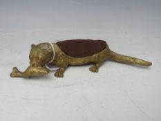 AN AUSTRIAN BRONZE PIN CUSHION IN THE SHAPE OF AN OTTER WITH A FISH, marked GESCHATZT, L 19 cm