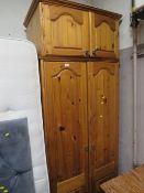 A HONEY PINE DOUBLE WARDROBE WITH TOP BOX