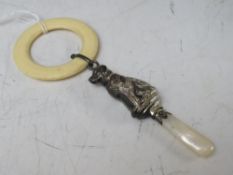 A HALLMARKED SILVER CHILDS RATTLE IN THE SHAPE OF A DOG, with teething ring