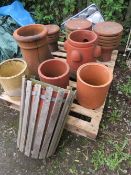 A SELECTION OF TERRACOTTA PLANTERS TO INCLUDE CHIMNEY COWLS POTS AND A STRAWBERRY PLANTER PLUS A