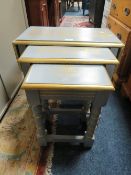 A NEST OF PAINTED OAK TABLES